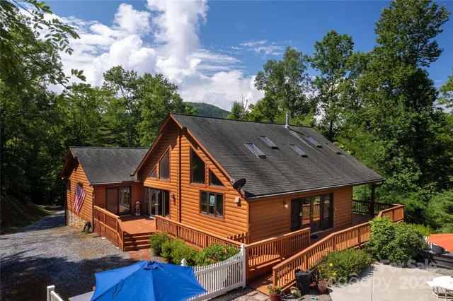 an aerial view of a house with yard porch and furniture