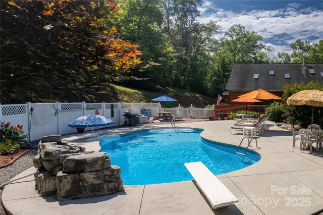 an aerial view of a house with a garden and lake view