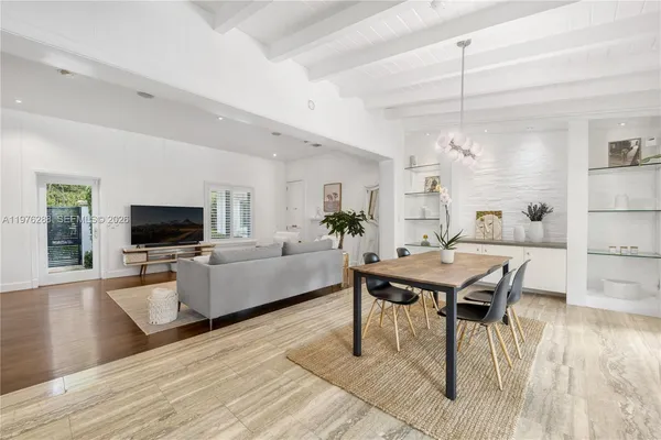 a living room with furniture wooden floor and a flat screen tv