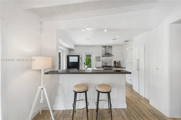 a kitchen with a table and chairs in it