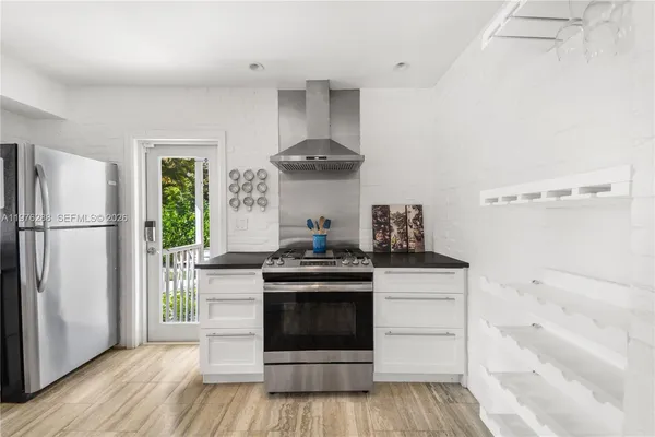 a kitchen with stainless steel appliances a stove and a refrigerator