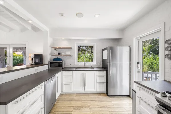 a kitchen with a refrigerator a stove a sink dishwasher and wooden cabinets with wooden floor
