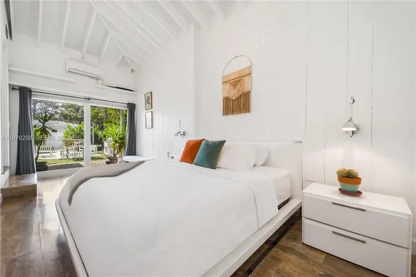 a bedroom with a large bed and a large window