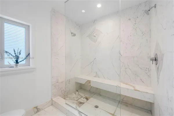 a bathroom with a bathtub and shower