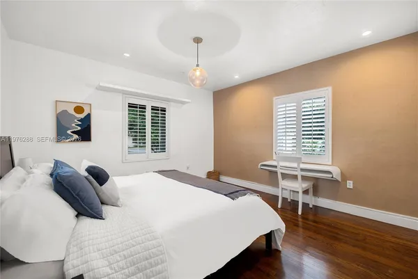 a bedroom with a bed and a desk