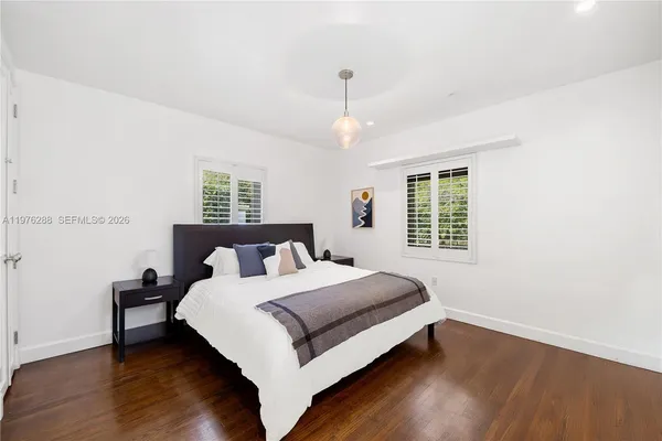 a bedroom with a bed and a table