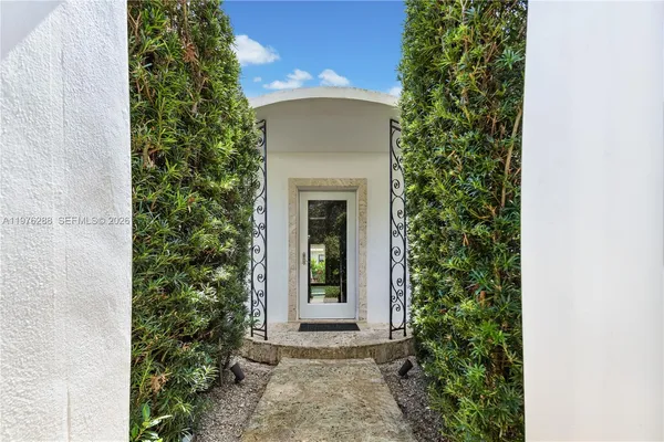 a front view of a house with plants