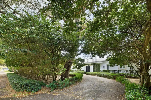 a view of a house with a tree in the background