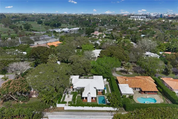 an aerial view of a house with a yard