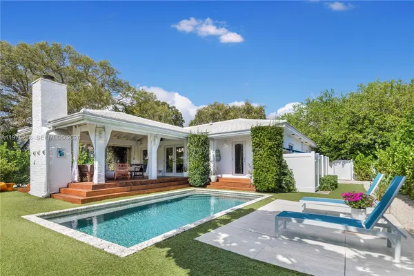 a view of house with outdoor space and swimming pool