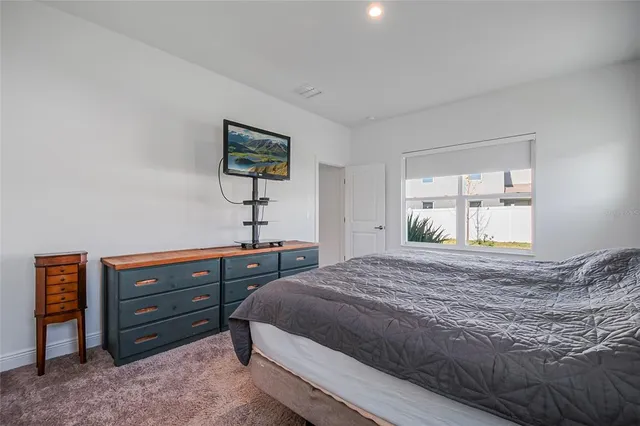 a bedroom with a bed and a dresser