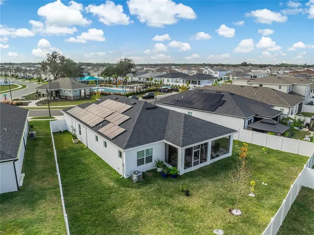 a aerial view of a house next to a big yard
