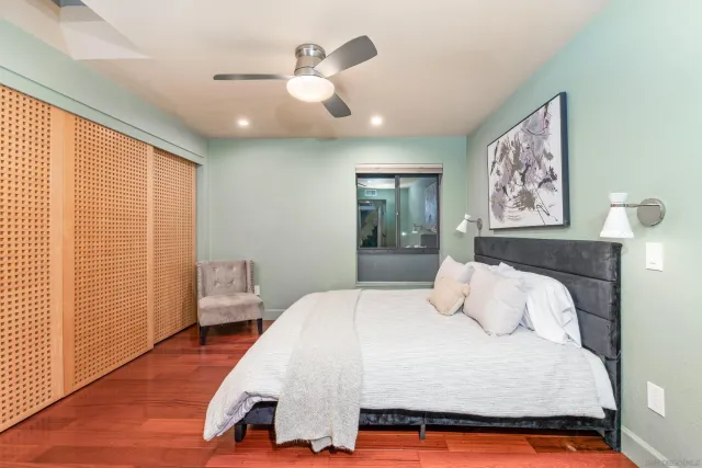 a bedroom with a large bed and a chandelier