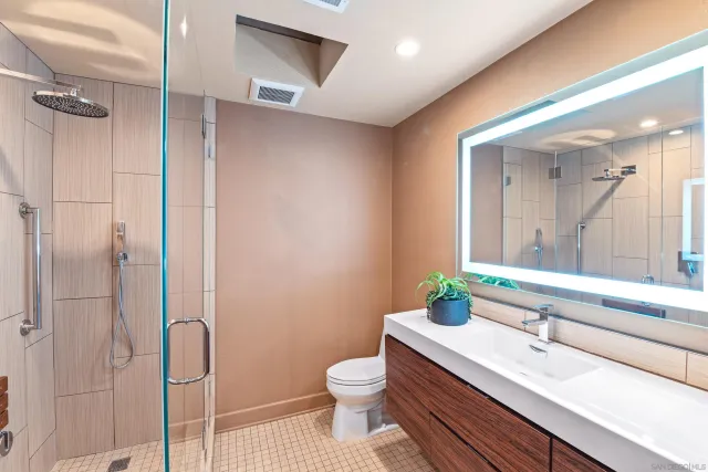 a bathroom with a sink a toilet and shower