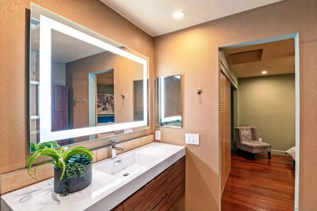 a bath room with a sink and a mirror