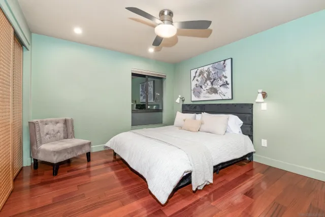 a bedroom with a bed and a chandelier