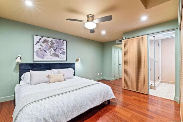a bedroom with a large bed and a chandelier