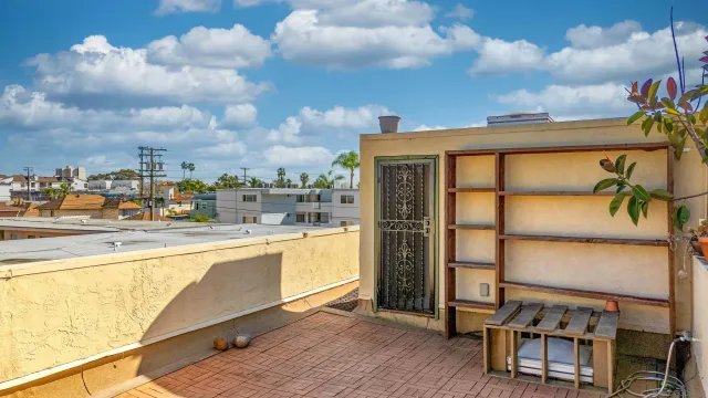 a view of front door of house with potted plants