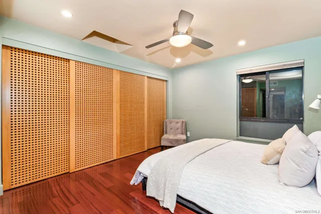 a bedroom with a large bed and a chandelier