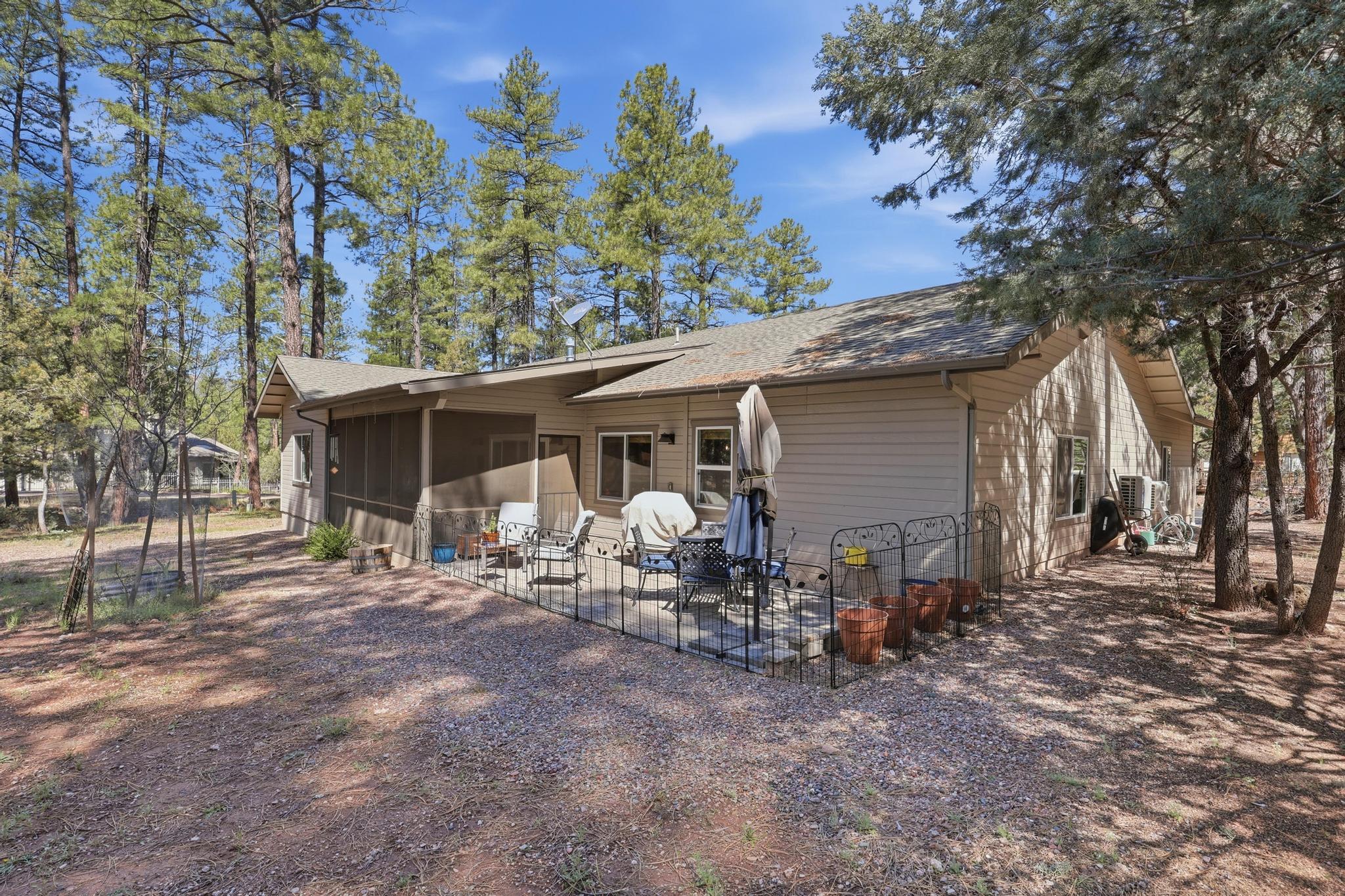 5501 Solitude Trail Loop Pine, AZ 85544 - Photo 25 of 27 a view of house with backyard space and patio