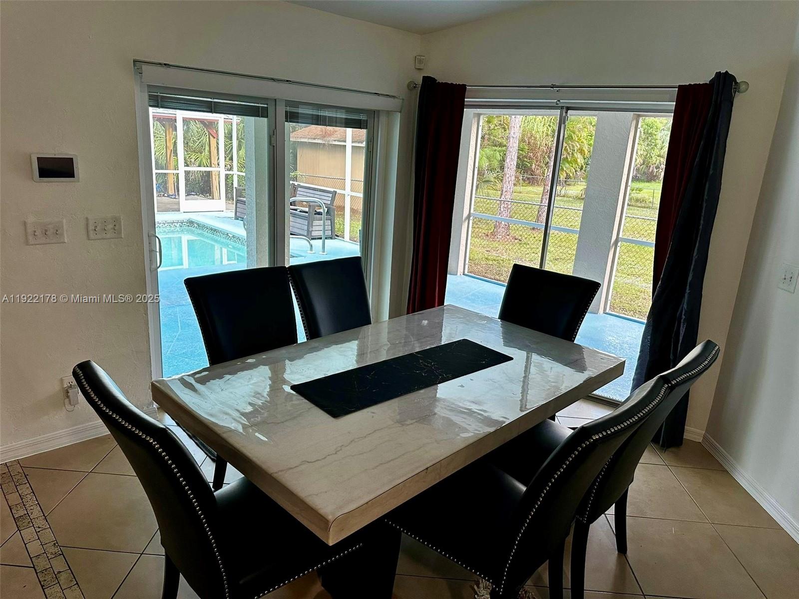 530 7th Street Southwest Naples, FL 34117 - Photo 16 of 32 a view of a dining room with a table and chairs