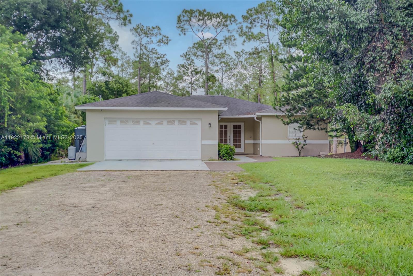 530 7th Street Southwest Naples, FL 34117 - Photo 2 of 32 a front view of house with yard and trees