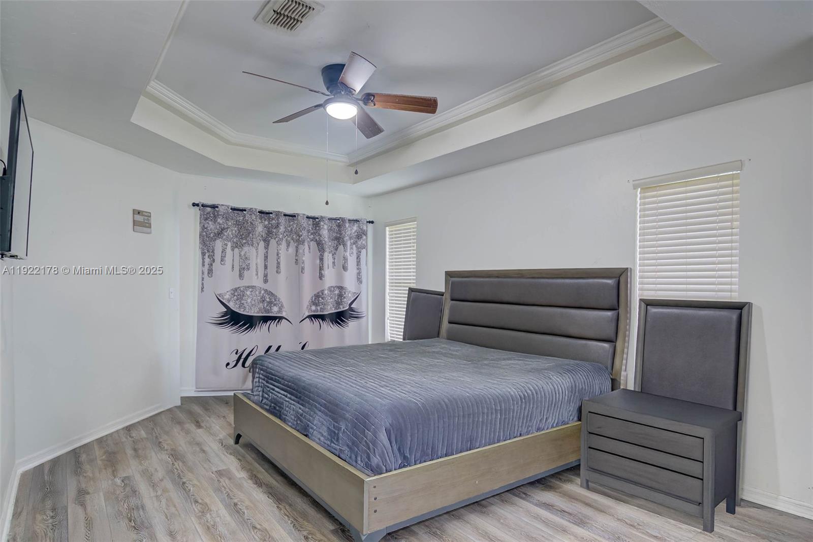 530 7th Street Southwest Naples, FL 34117 - Photo 22 of 32 a bedroom with a bed and a chandelier