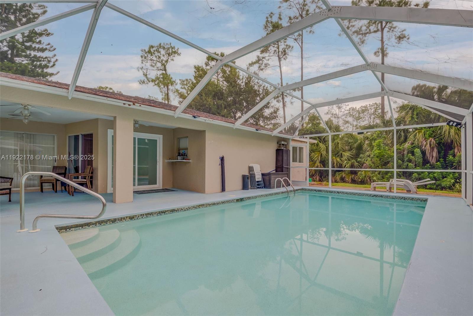 530 7th Street Southwest Naples, FL 34117 - Photo 25 of 32 a view of a swimming pool with a patio
