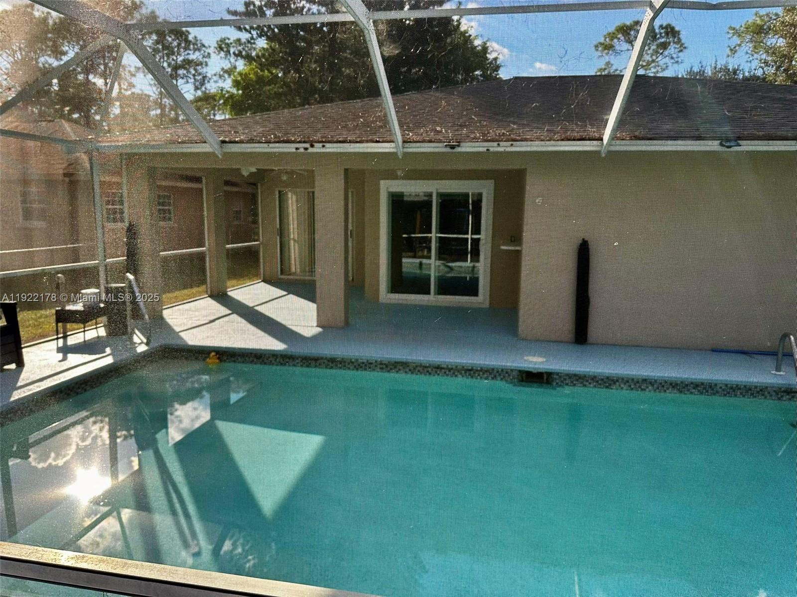 530 7th Street Southwest Naples, FL 34117 - Photo 26 of 32 a backyard of a house with seating space