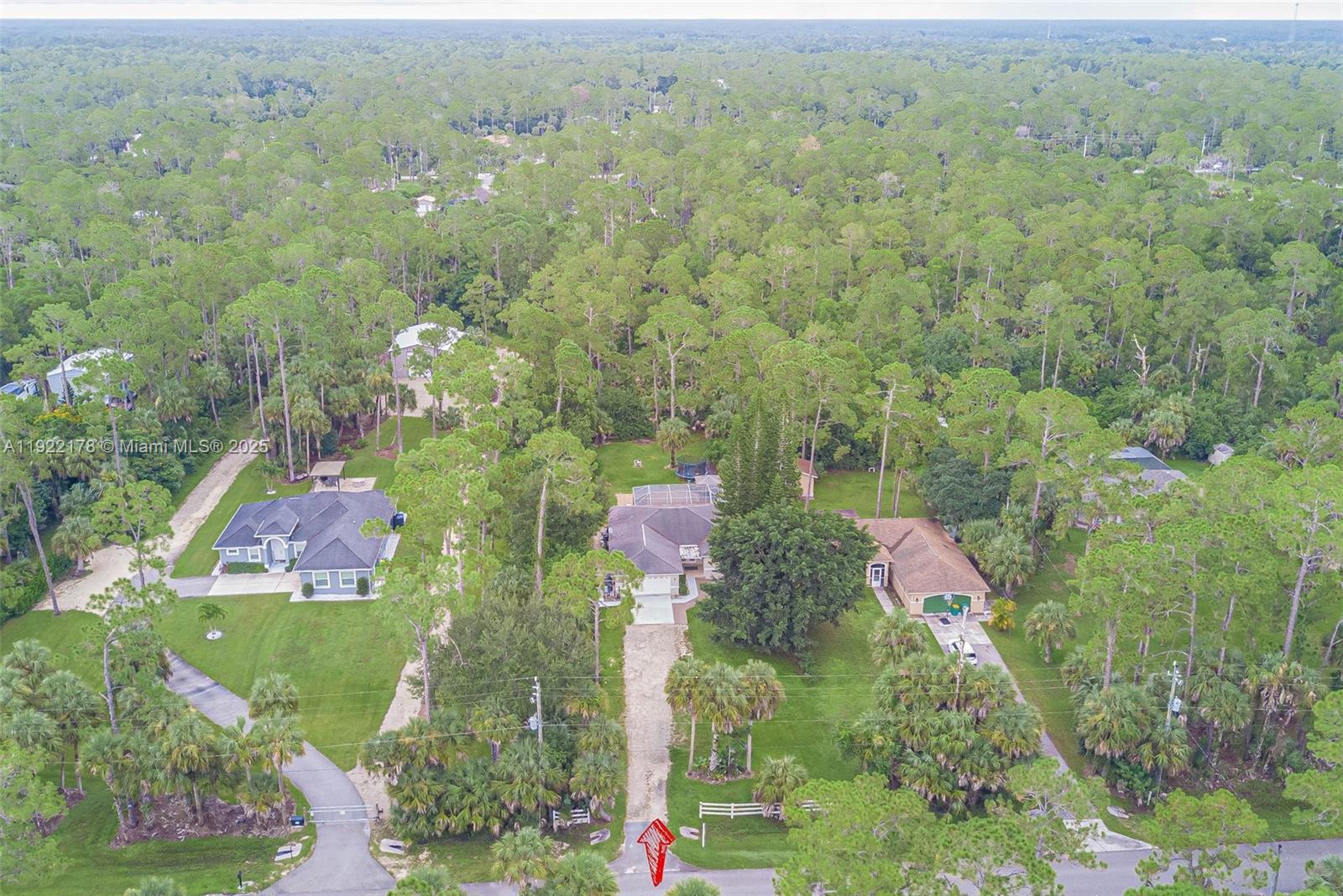 530 7th Street Southwest Naples, FL 34117 - Photo 31 of 32 an aerial view of residential houses with outdoor space and trees