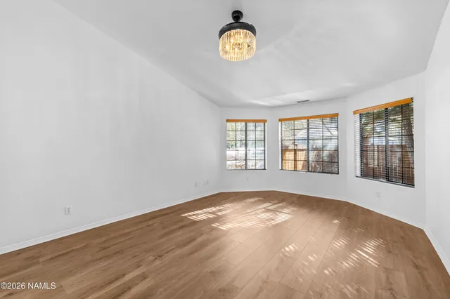 a view of a room with wooden floor