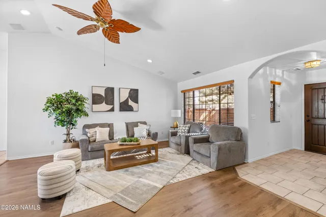 a living room with furniture a fireplace and a flat screen tv