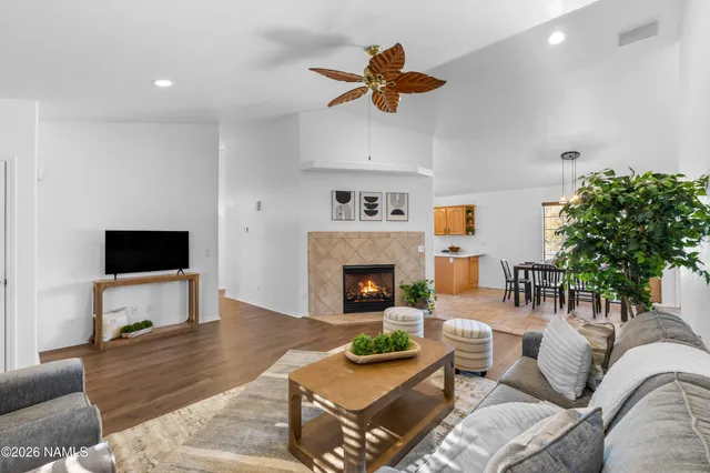 a living room with furniture potted plant and a fireplace