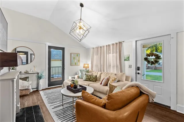 a living room with furniture wooden floor and a window