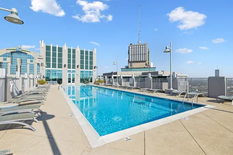 a view of a swimming pool and outdoor seating