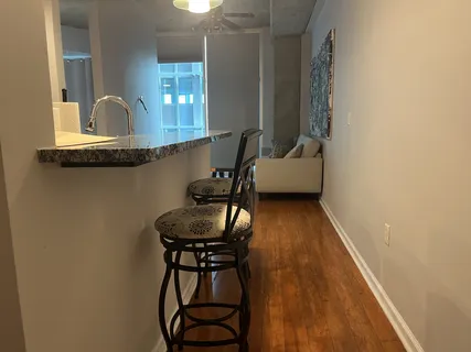 a dining room with furniture and wooden floor