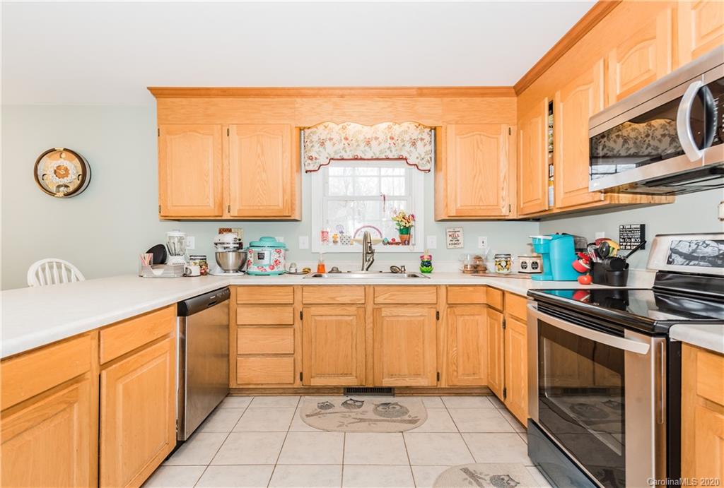 3130 Bush Road Clover, SC 29710 - Photo 8 of 25 a kitchen with stainless steel appliances granite countertop a sink and cabinets