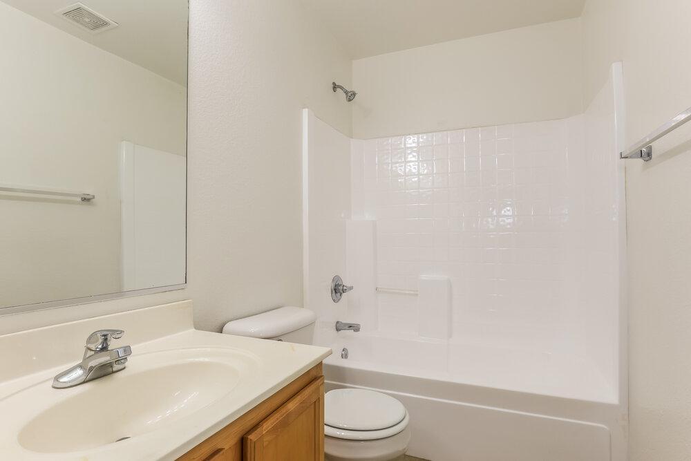 9415 Virginia Avenue Phoenix, AZ 85037 - Photo 11 of 17 a bathroom with a sink a toilet and shower