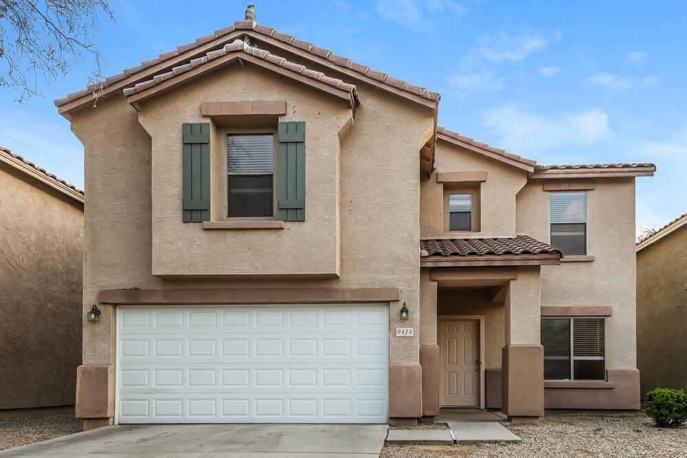 9415 Virginia Avenue Phoenix, AZ 85037 - Photo 2 of 17 a front view of a house with garage