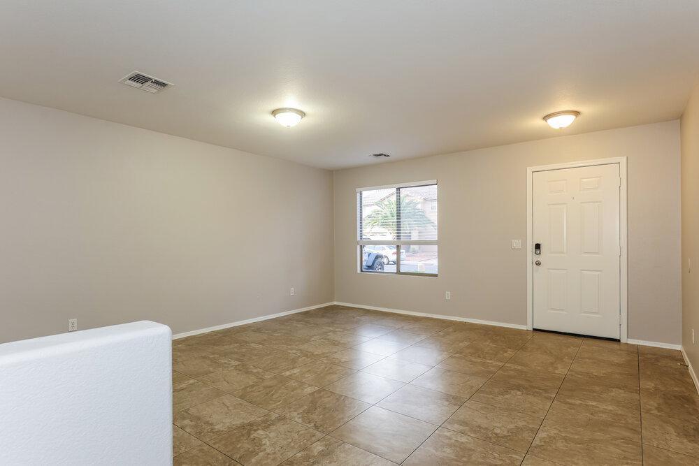 9415 Virginia Avenue Phoenix, AZ 85037 - Photo 4 of 17 a view of an empty room with a window