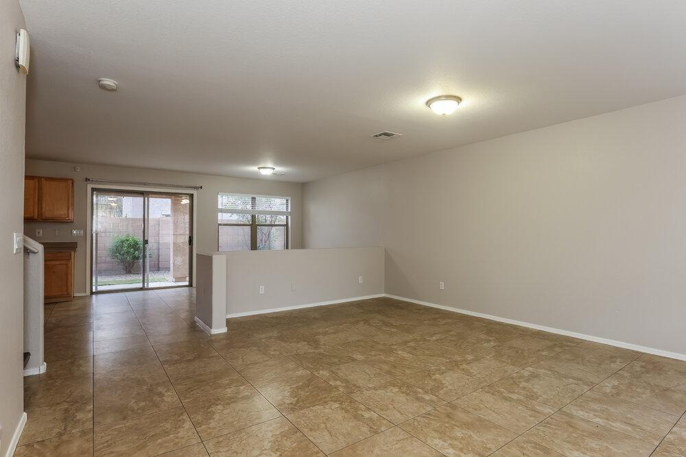 9415 Virginia Avenue Phoenix, AZ 85037 - Photo 6 of 17 wooden floor in an empty room with a window