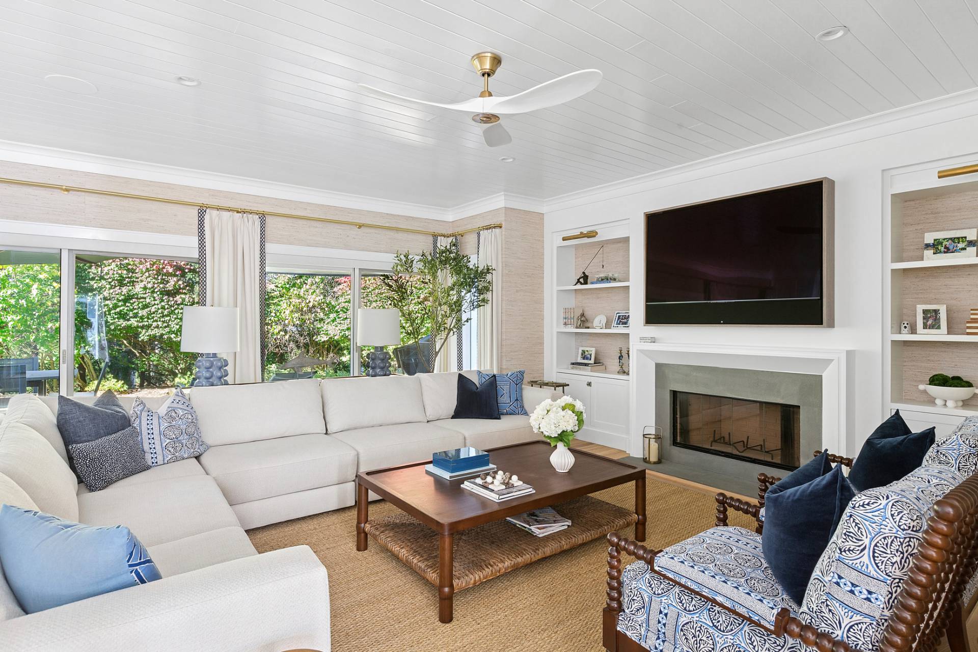 a living room with furniture a flat screen tv and a fireplace