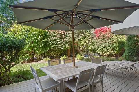a view of a table and chairs under an umbrella