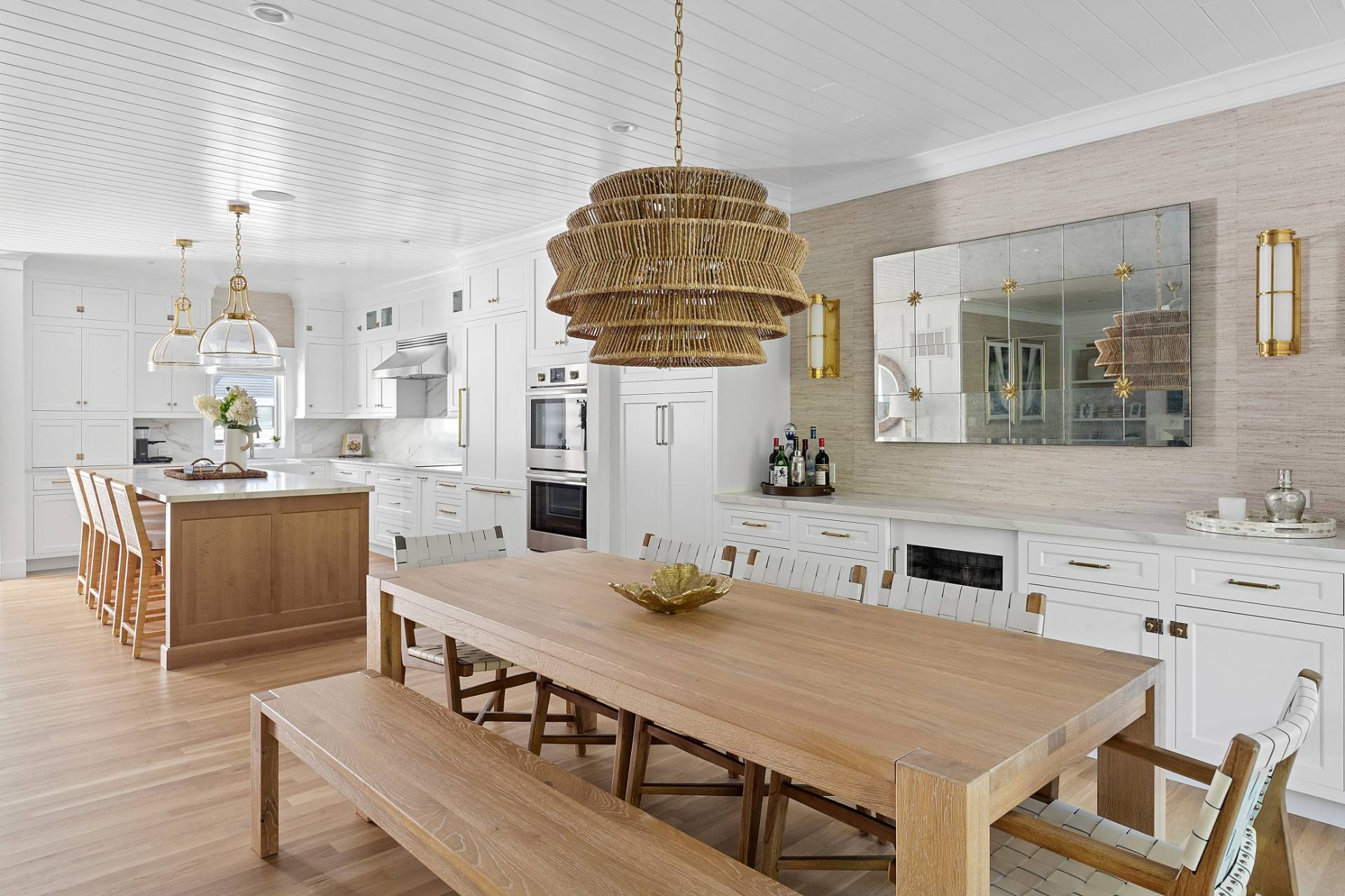 9 Reed Pond Court Water Mill, NY 11976 - Photo 5 of 13 a kitchen with a dining table chairs and white cabinets