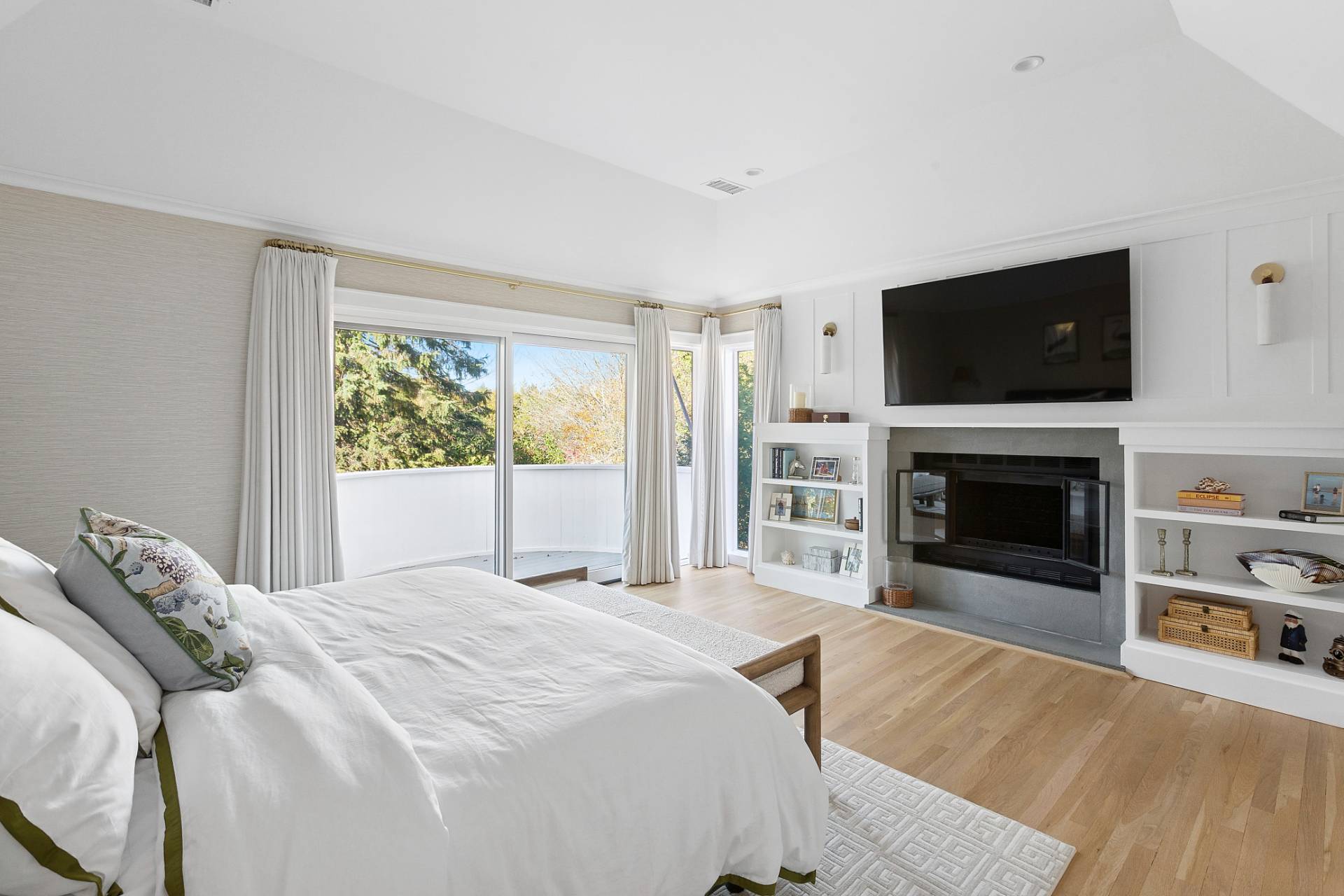 9 Reed Pond Court Water Mill, NY 11976 - Photo 7 of 13 a spacious bedroom with a bed and a flat screen tv