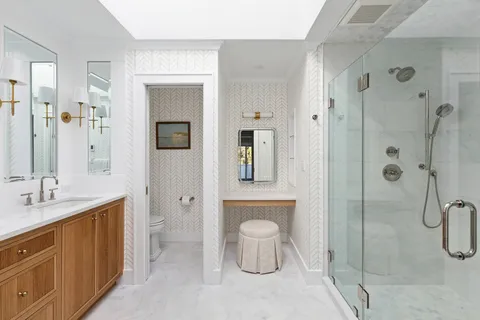 a bathroom with a shower sink and mirror