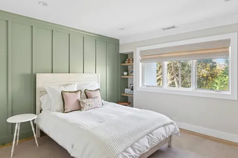 a bedroom with a bed and a window