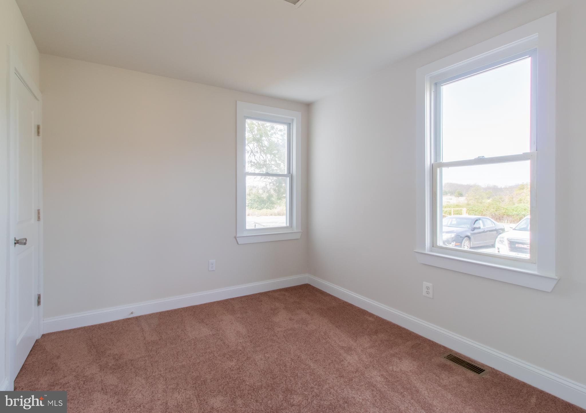 9440 Riggs Road Adelphi, MD 20783 - Photo 14 of 18 an empty room with windows