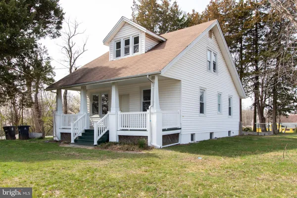 a view of a white house with a yard