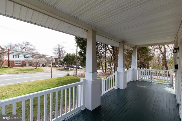 a view of a porch with wooden floor and roof